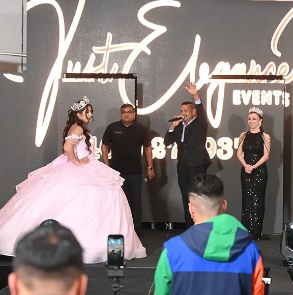 Quinceañera en el escenario con los presentadores